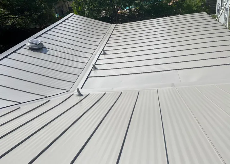 Solar attic fan installed on a metal roof for Roof Ventilation in Whitefish Bay
